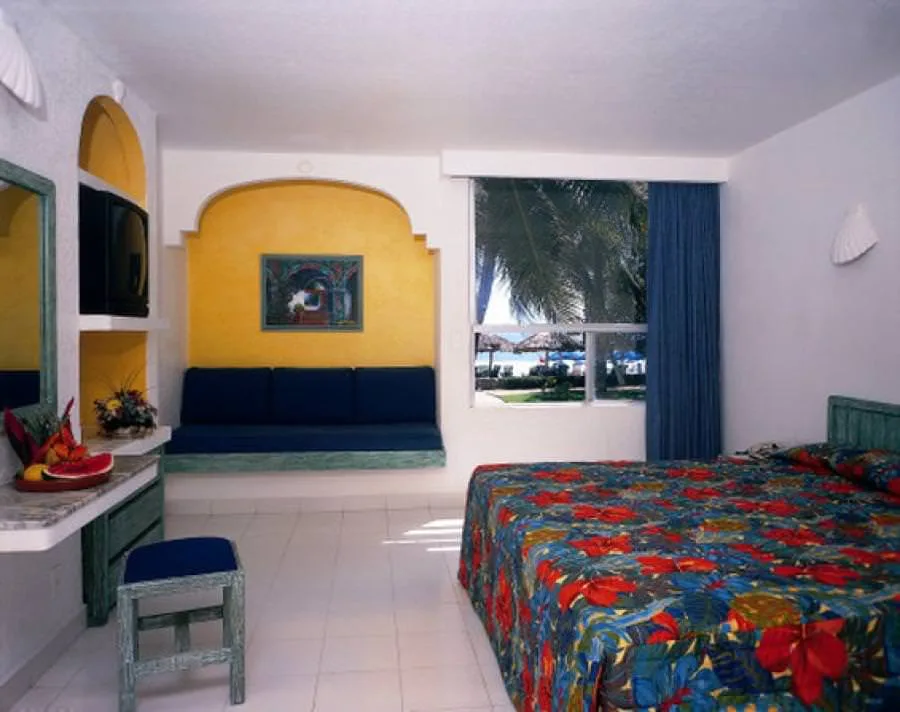 Superior Garden View room with king bed and window at Posada Real Ixtapa.