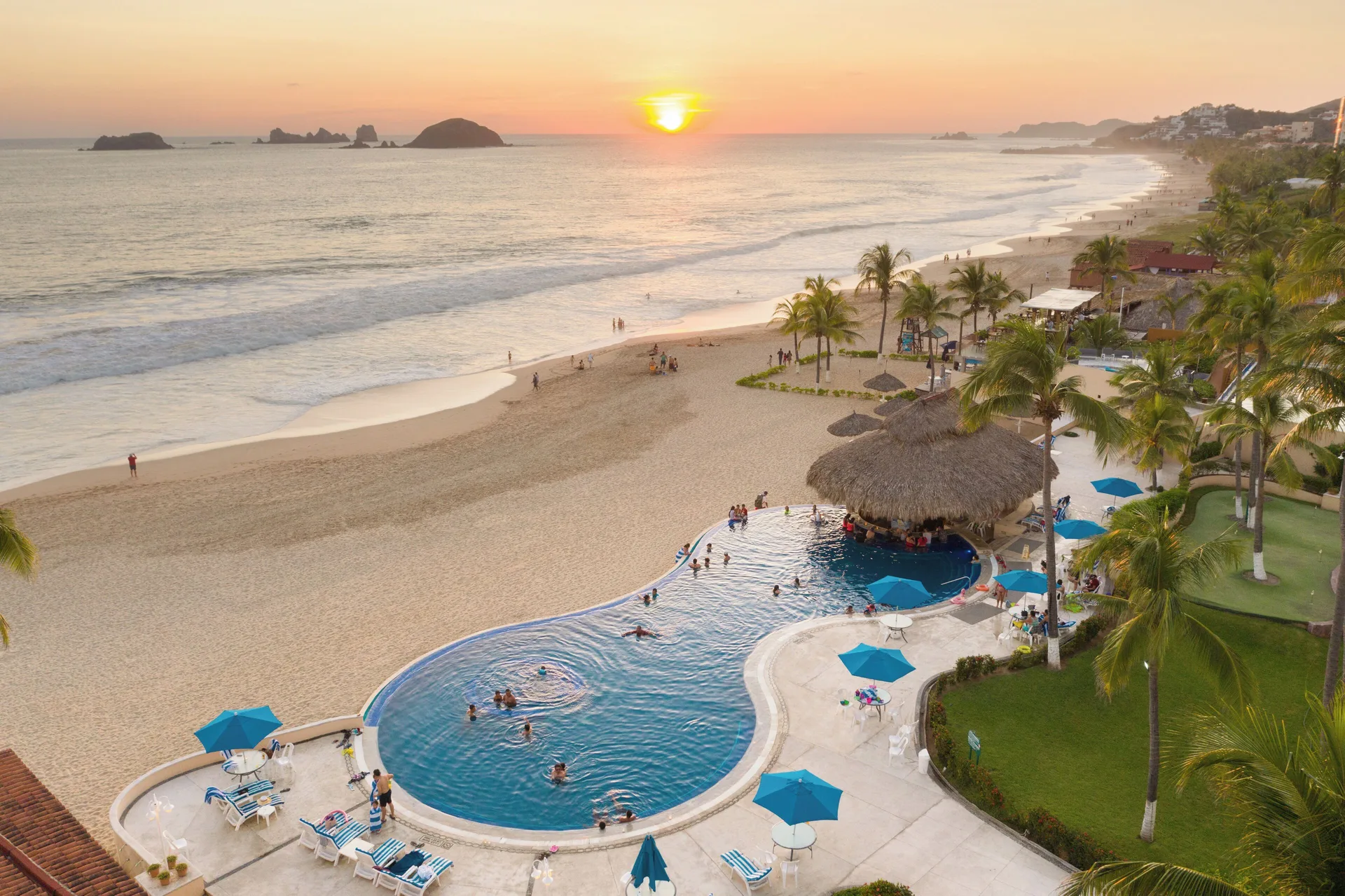 Terrace view of the pool, beach and sunset from Posada Real Ixtapa.