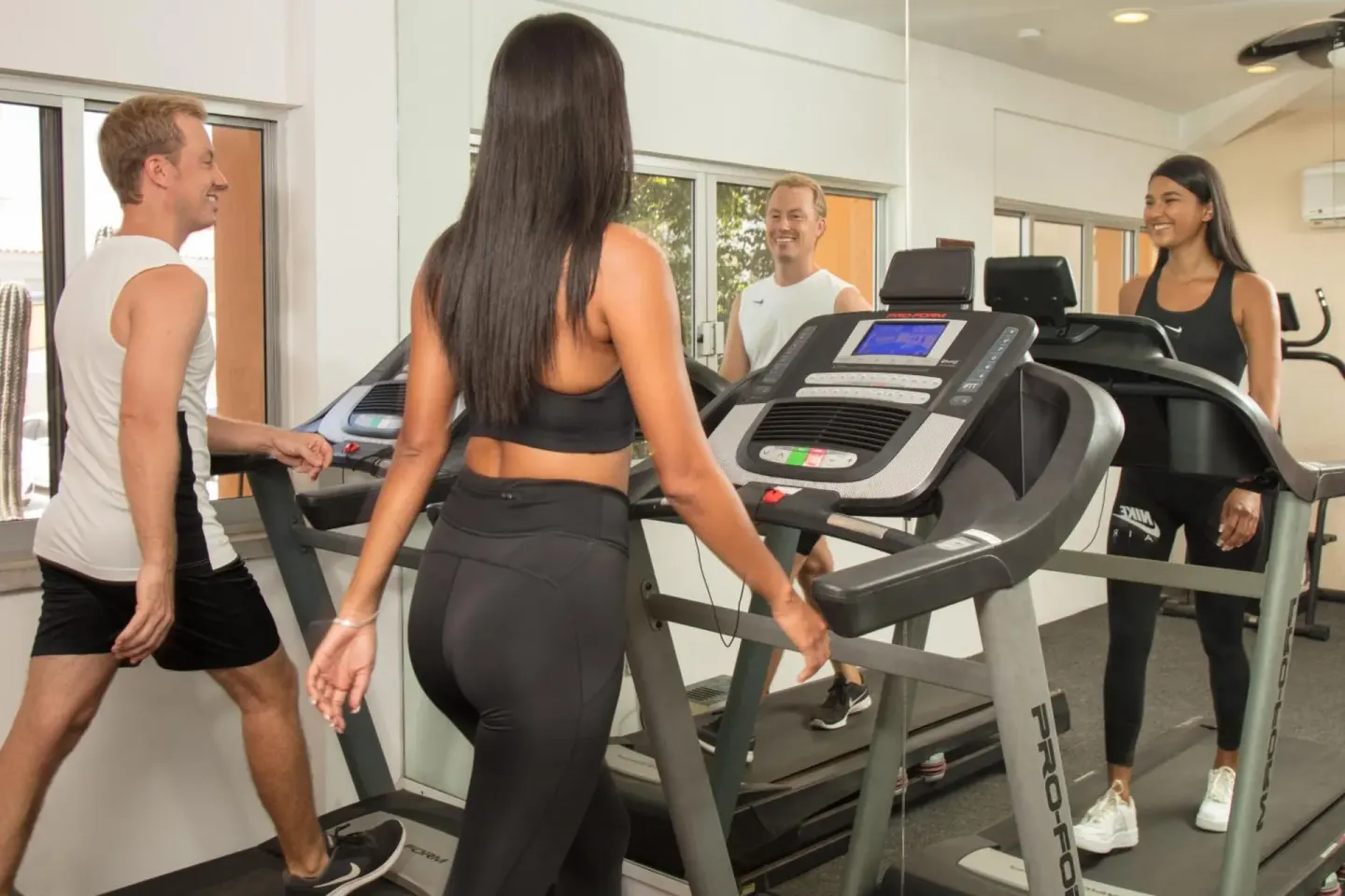 Guests walking on treadmills in the fitness room at Posada Real Los Cabos.