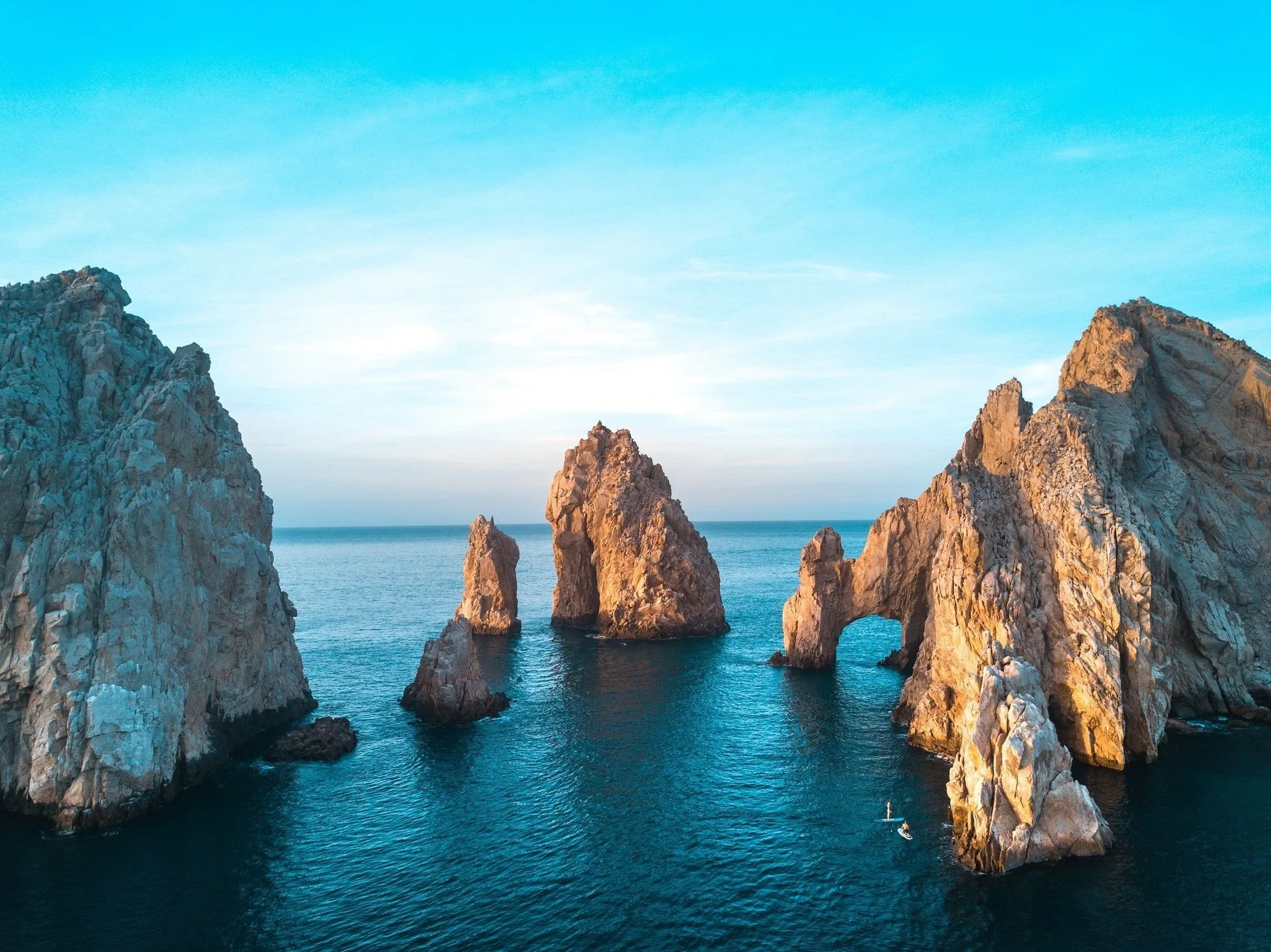 Rock formations rise from the sea near Los Cabos, shown as a local coastal landmark for Posada Real Los Cabos.