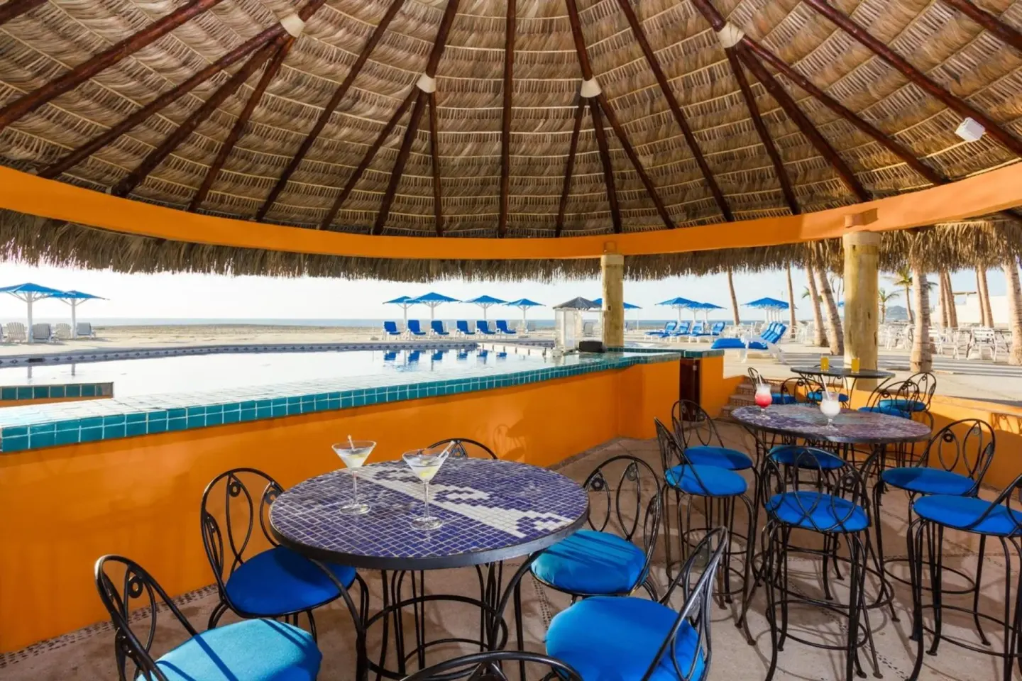 Palapa bar seating beside the pool and beach at Posada Real Los Cabos.