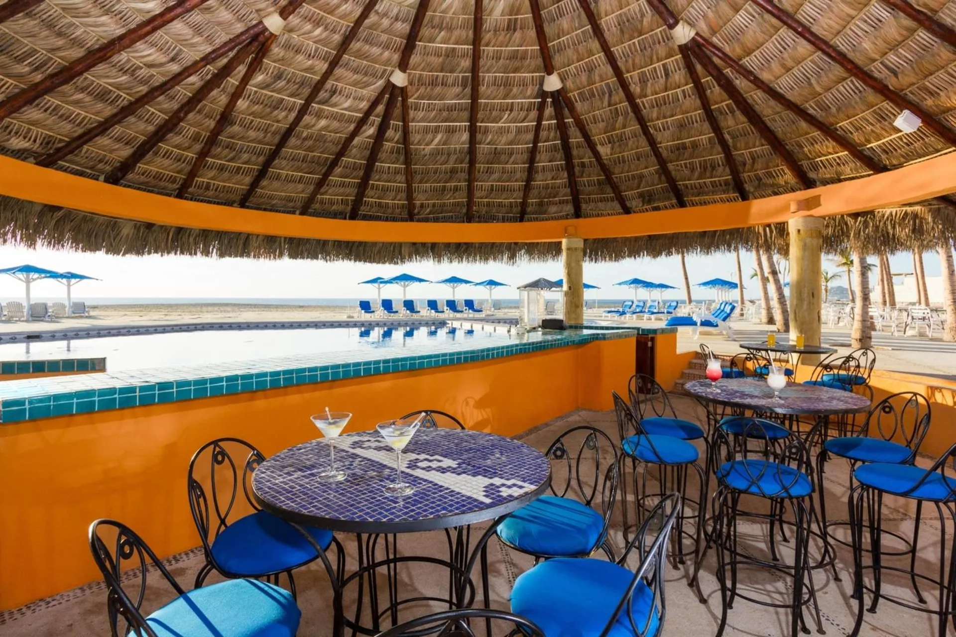 Palapa bar seating beside the pool and beach at Posada Real Los Cabos.
