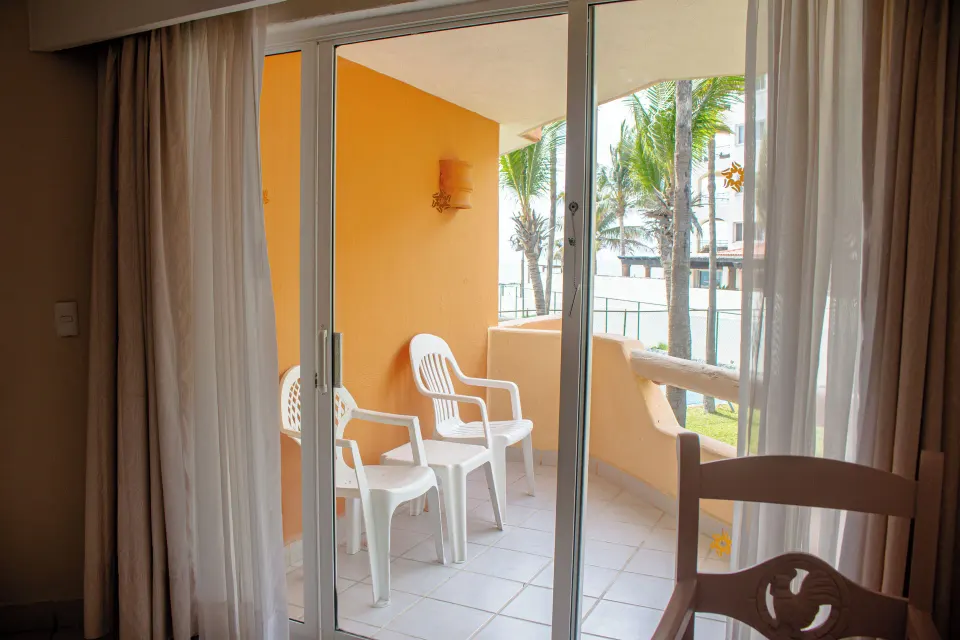 Sliding doors open from a standard room to a balcony at Posada Real Los Cabos.
