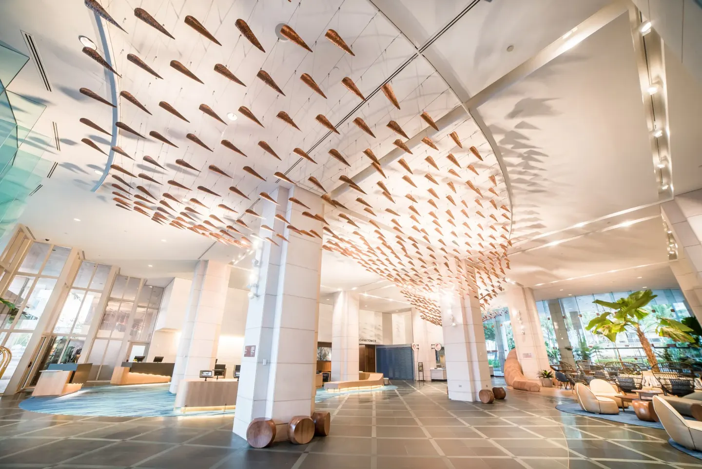 Prince Waikiki lobby with tall columns and a suspended ceiling art installation.
