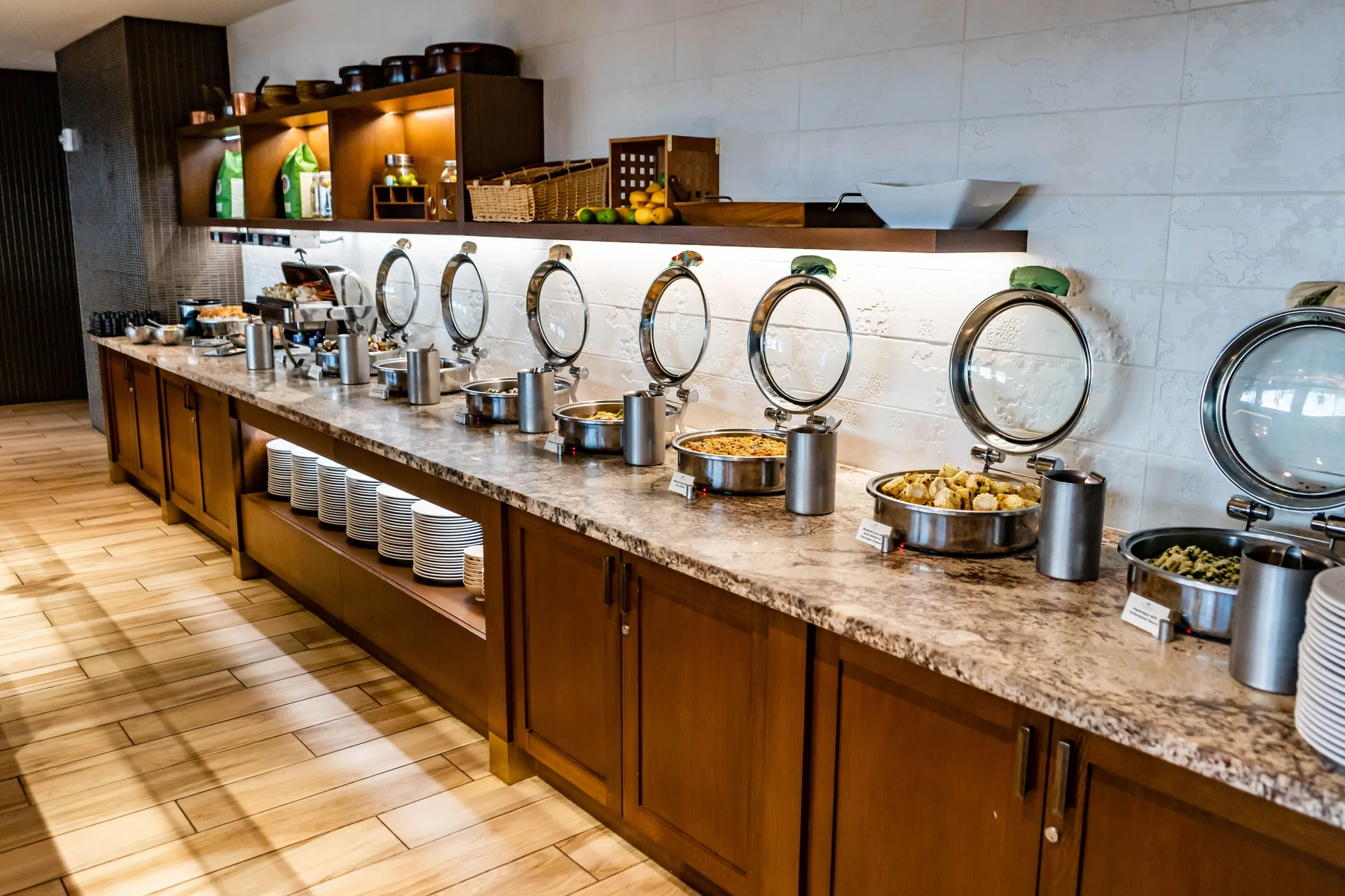 Buffet counter with covered hot dishes and plates at Prince Waikiki.