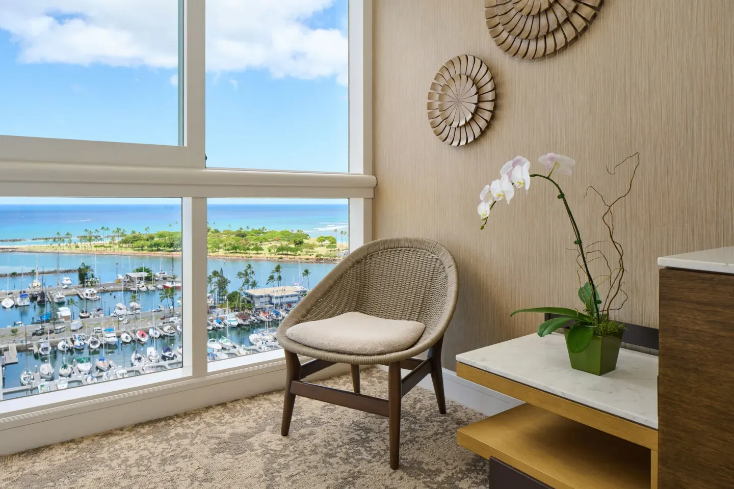 Club Premier Oceanfront seating nook with marina and ocean views at Prince Waikiki.