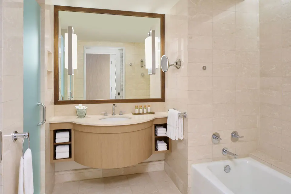 Ocean Front Harbor room bathroom with vanity and tub at Prince Waikiki.