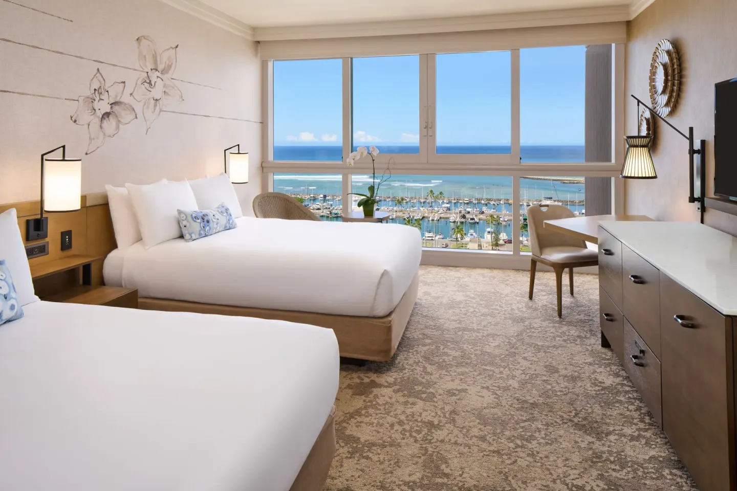 Ocean Front Harbor room at Prince Waikiki with two beds and wide windows overlooking the marina and ocean.