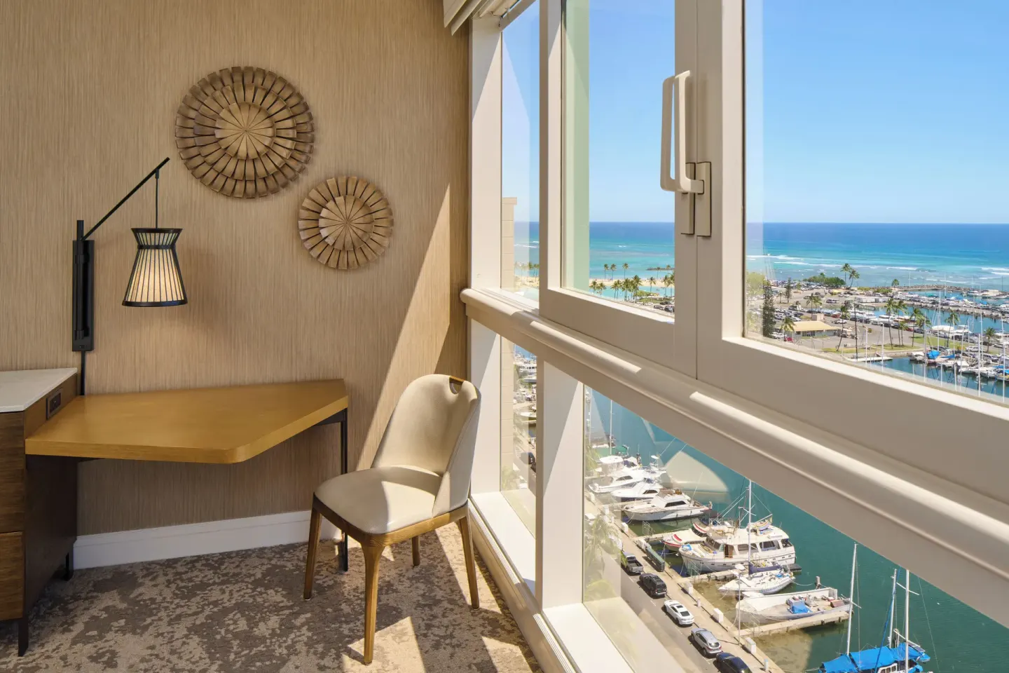 Ocean Front room desk beside marina and ocean windows at Prince Waikiki.