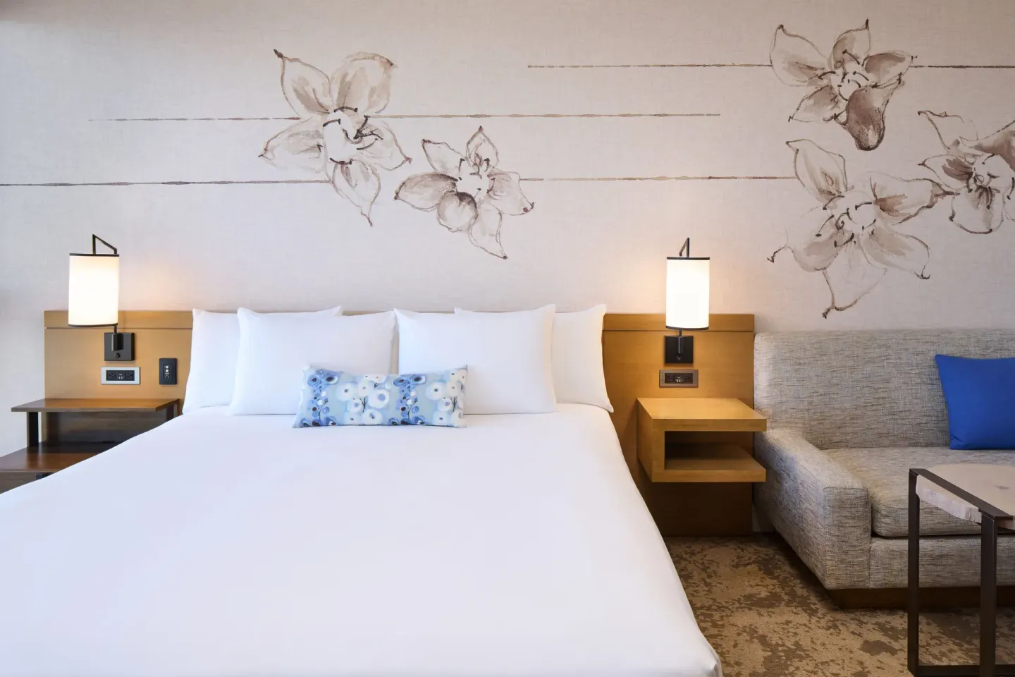 Ocean Front king bed with sofa and floral wall art at Prince Waikiki.