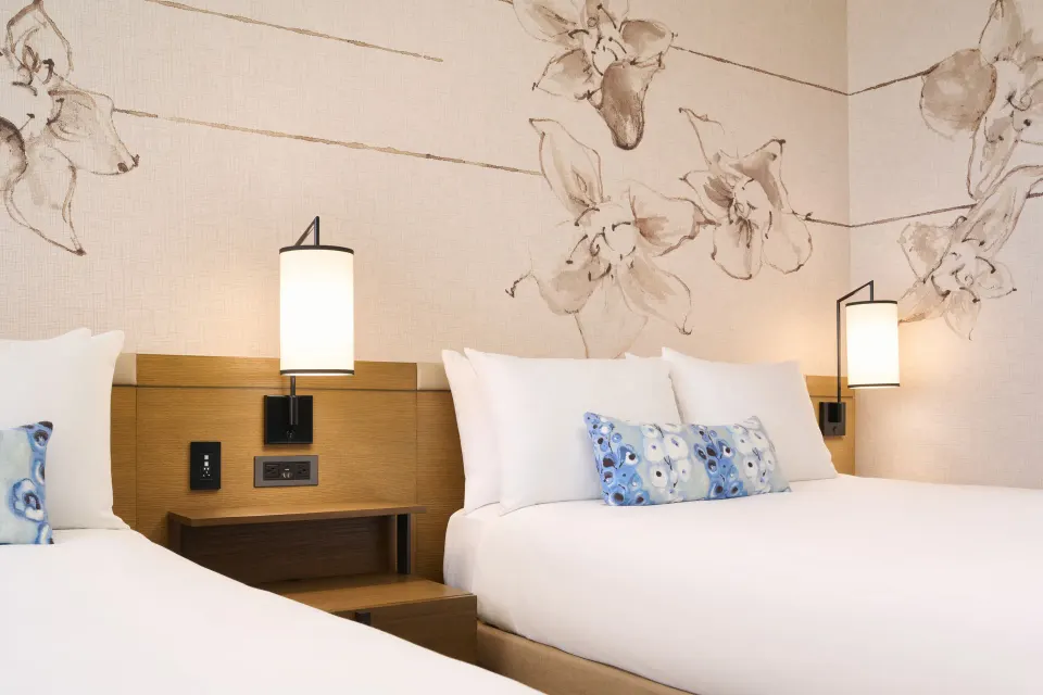 Ocean Front room beds with floral wall art at Prince Waikiki.