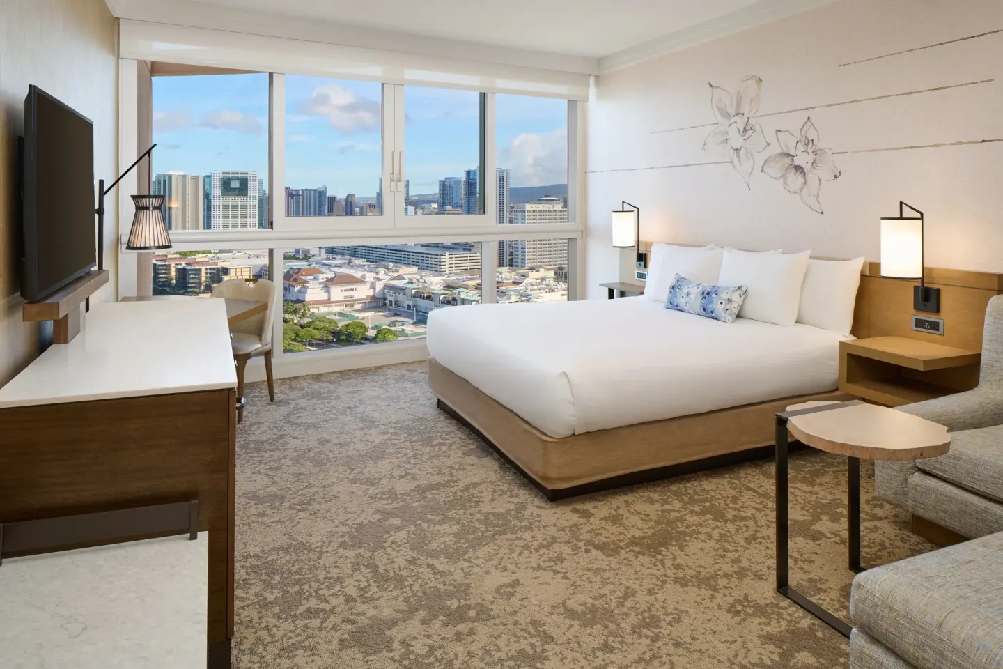 Ocean View Suite bedroom with king bed and city windows at Prince Waikiki.