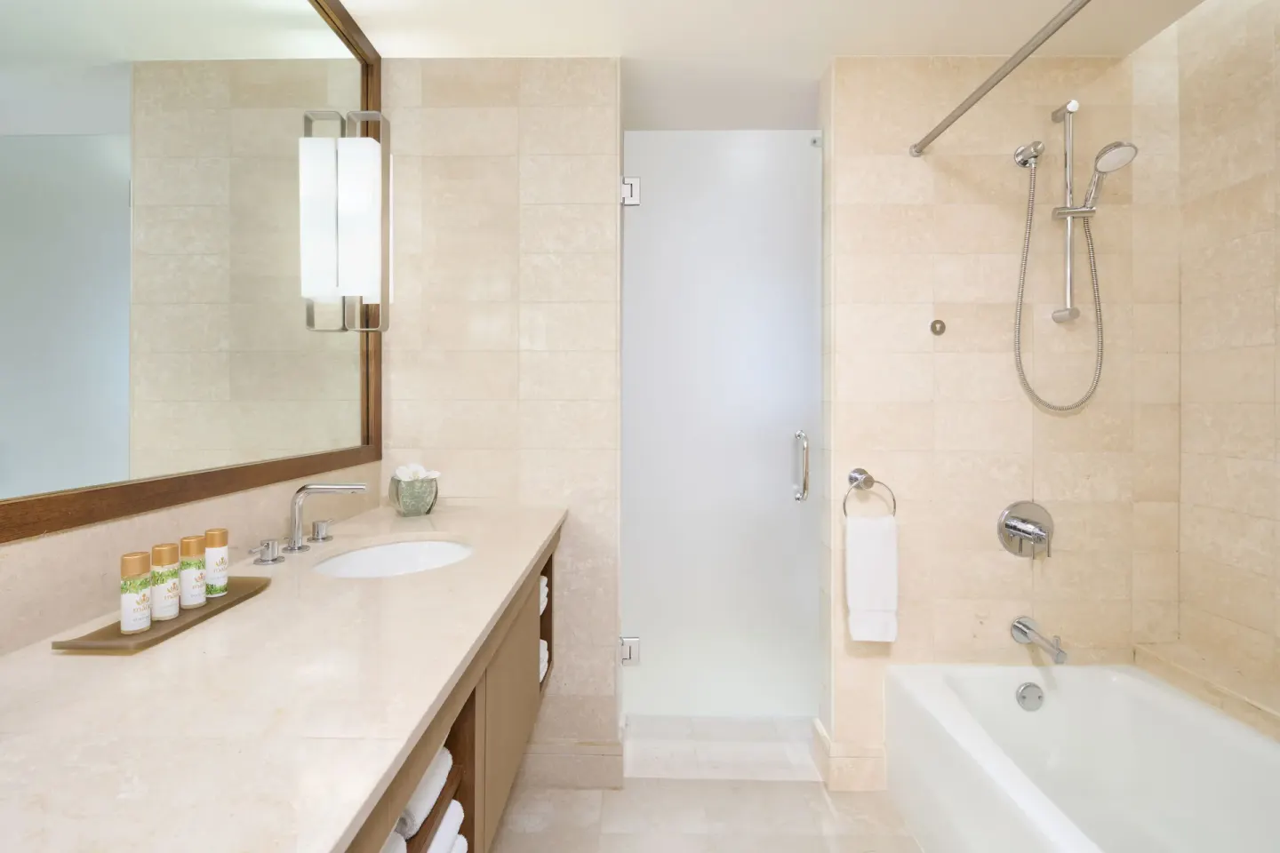 Ocean View room bathroom with vanity, shower, bathtub, and bath amenities at Prince Waikiki.