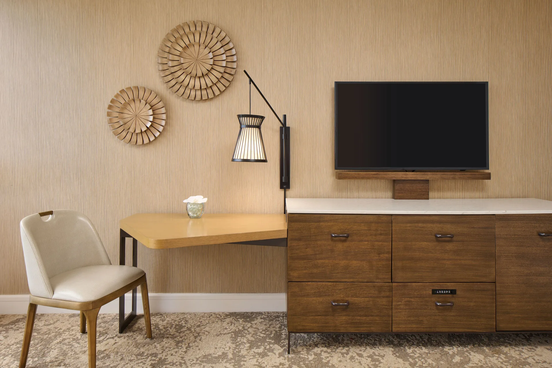 Ocean View room desk, chair, dresser, TV, lamp, and wall decor at Prince Waikiki.