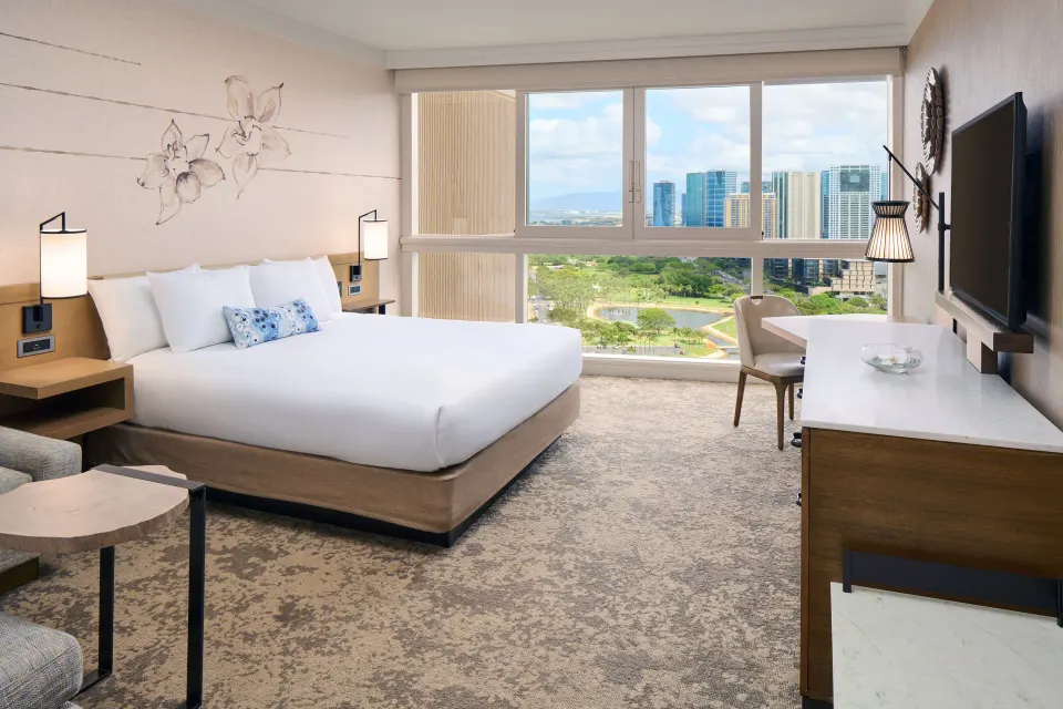 Ocean View room with king bed, desk, TV, and city and water views at Prince Waikiki.