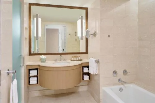 Oceanfront Harbor View Room bathroom with vanity and tub at Prince Waikiki.