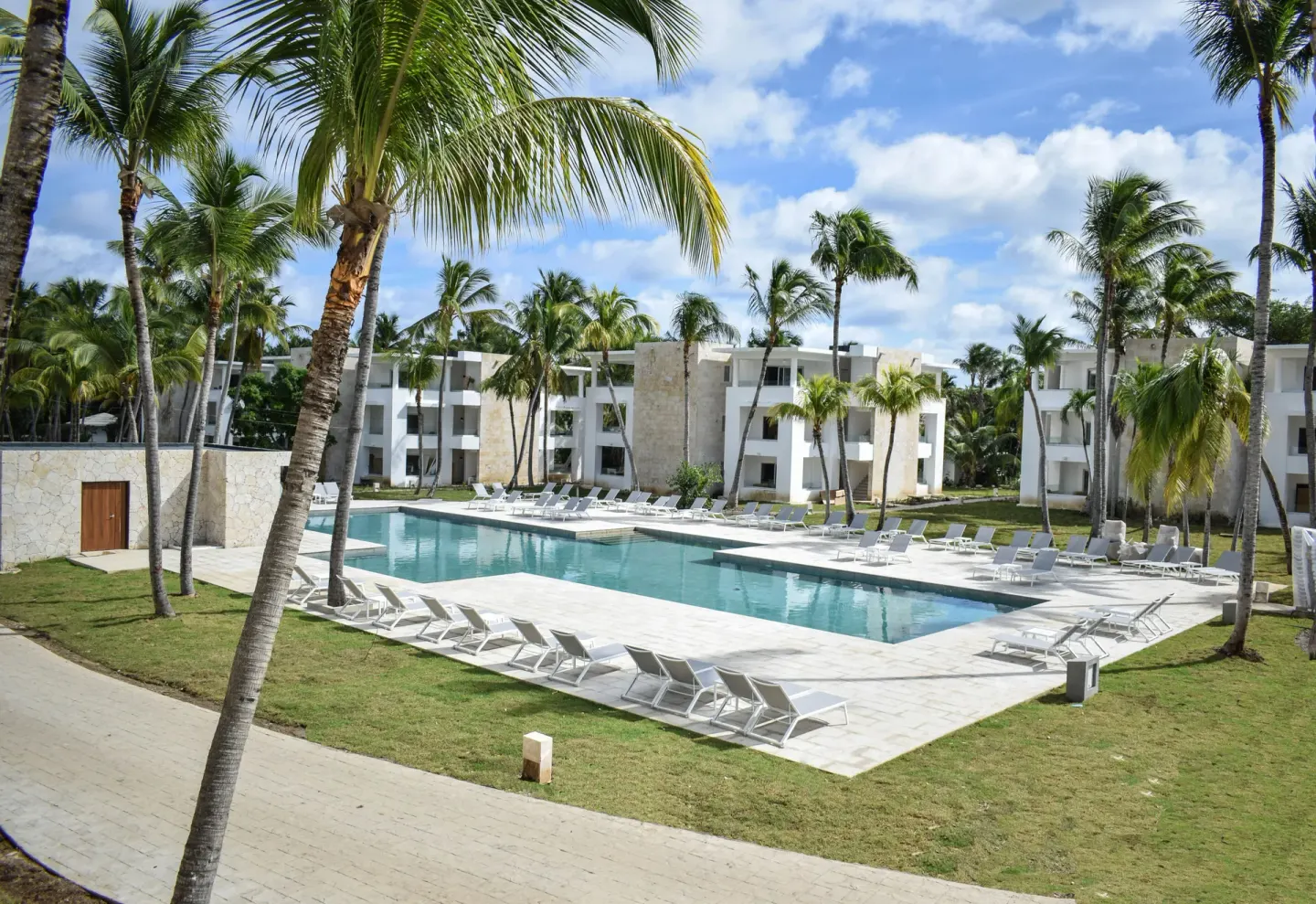 Elevated view of a palm-framed pool and loungers at Princess Family Club Bavaro.