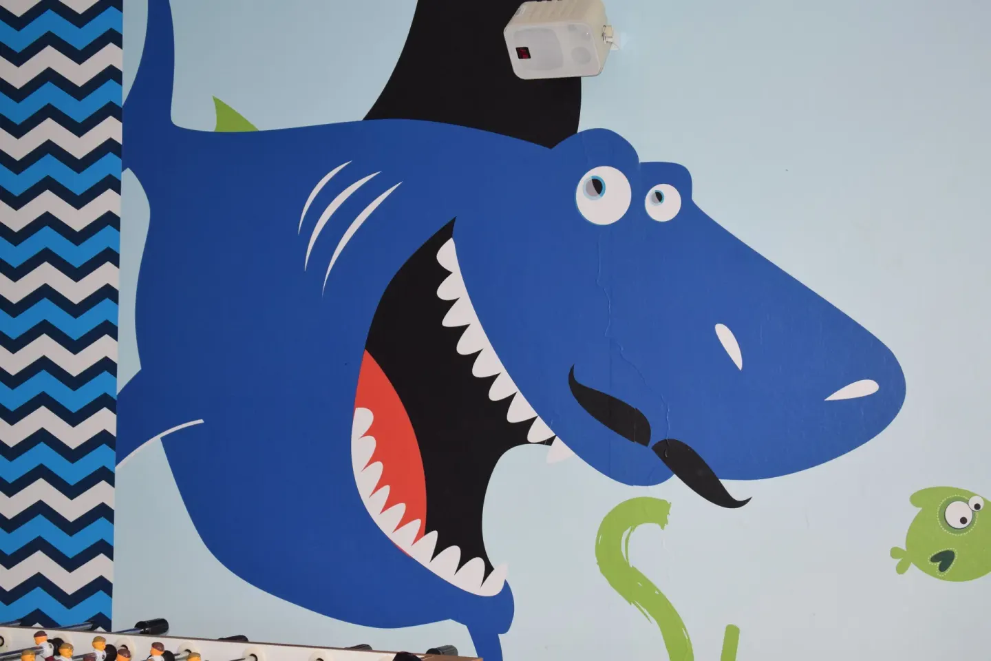 Colorful shark mural in the kids area at Princess Family Club Bavaro.