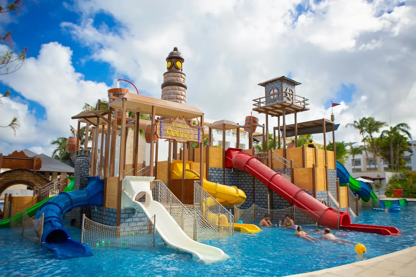 Children playing by the pirate-themed pool slides at Princess Family Club Bavaro.