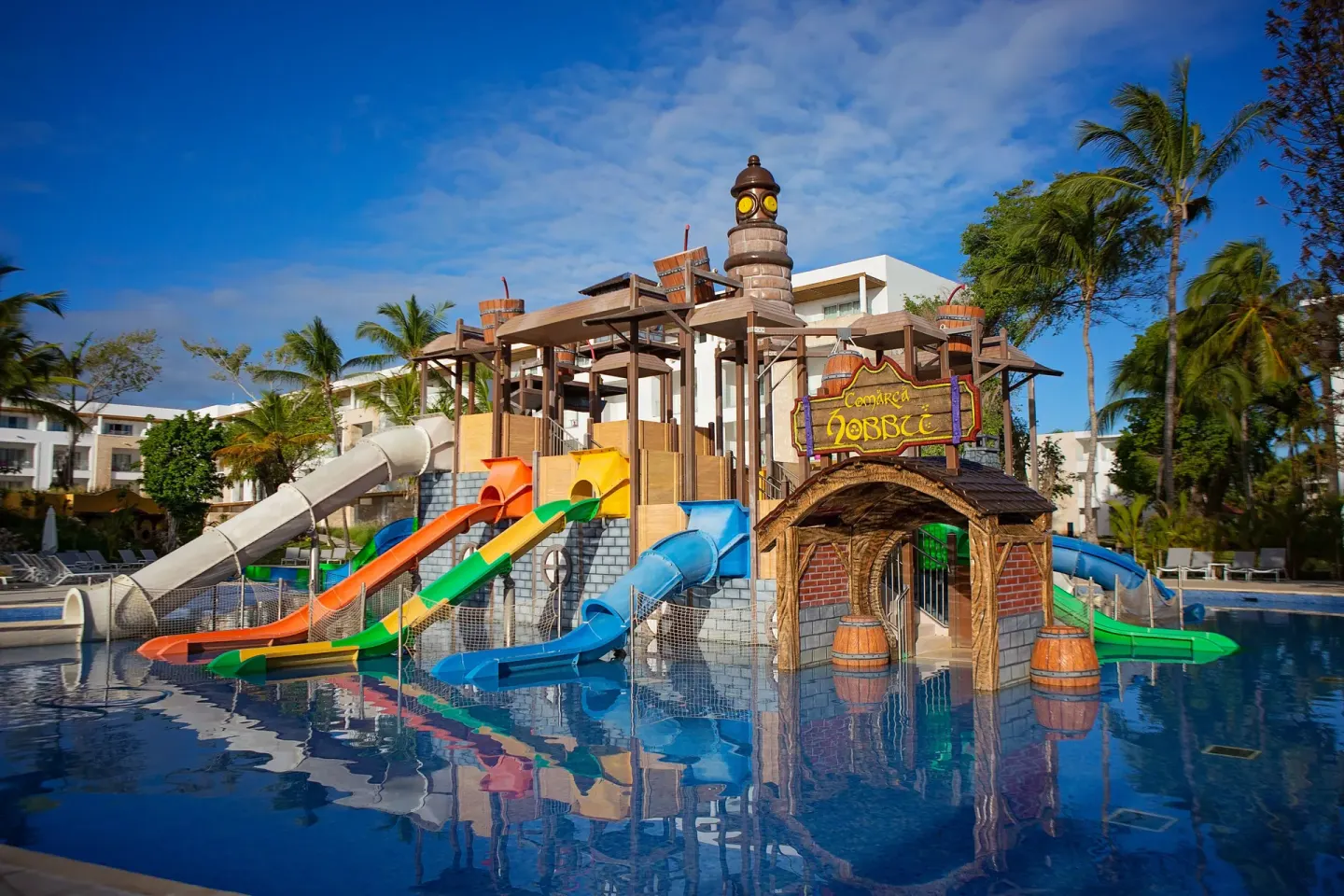 Pirate water park with several slides and a themed entrance at Princess Family Club Bavaro.