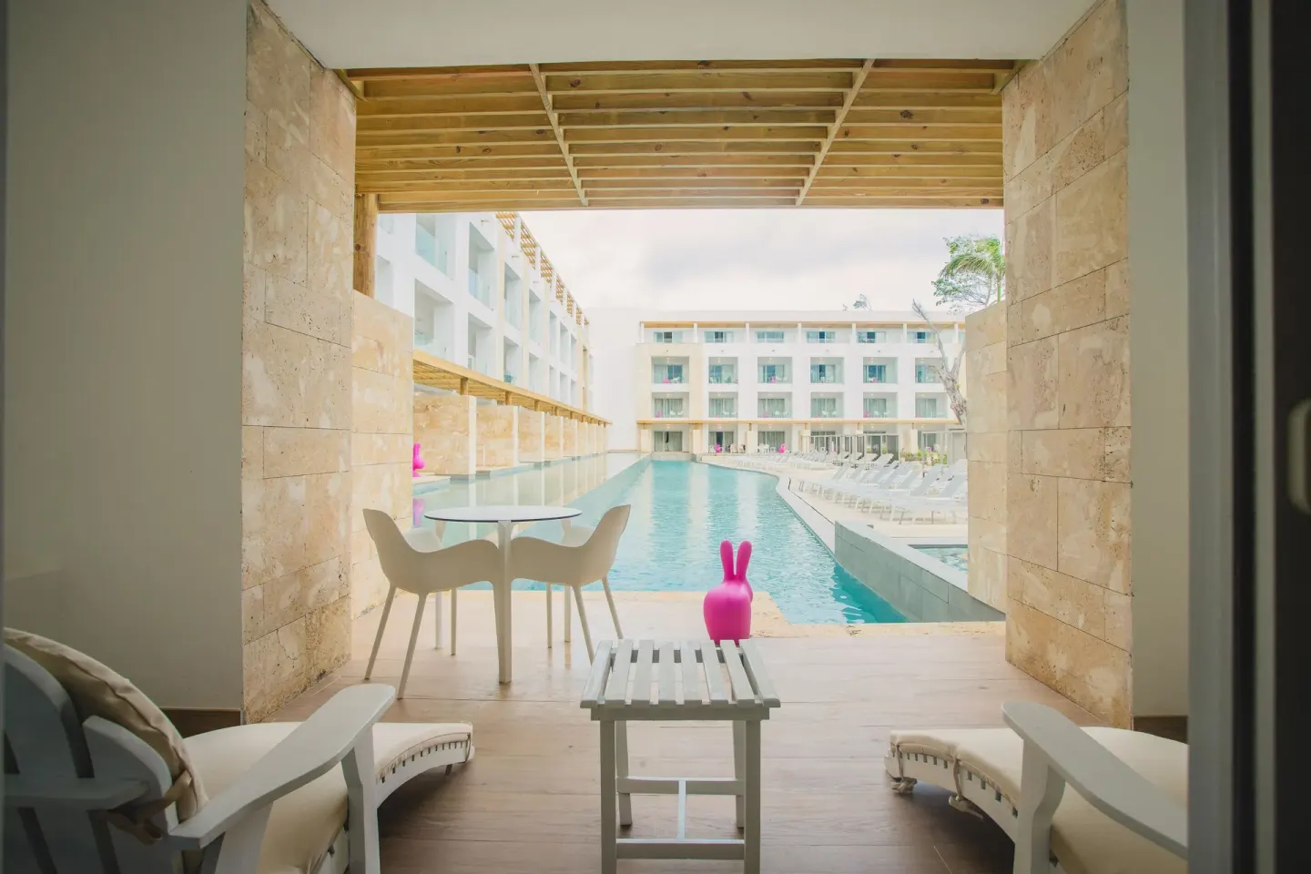 Terrace with lounge chairs looking onto a swim-up pool at Princess Family Club Bavaro.