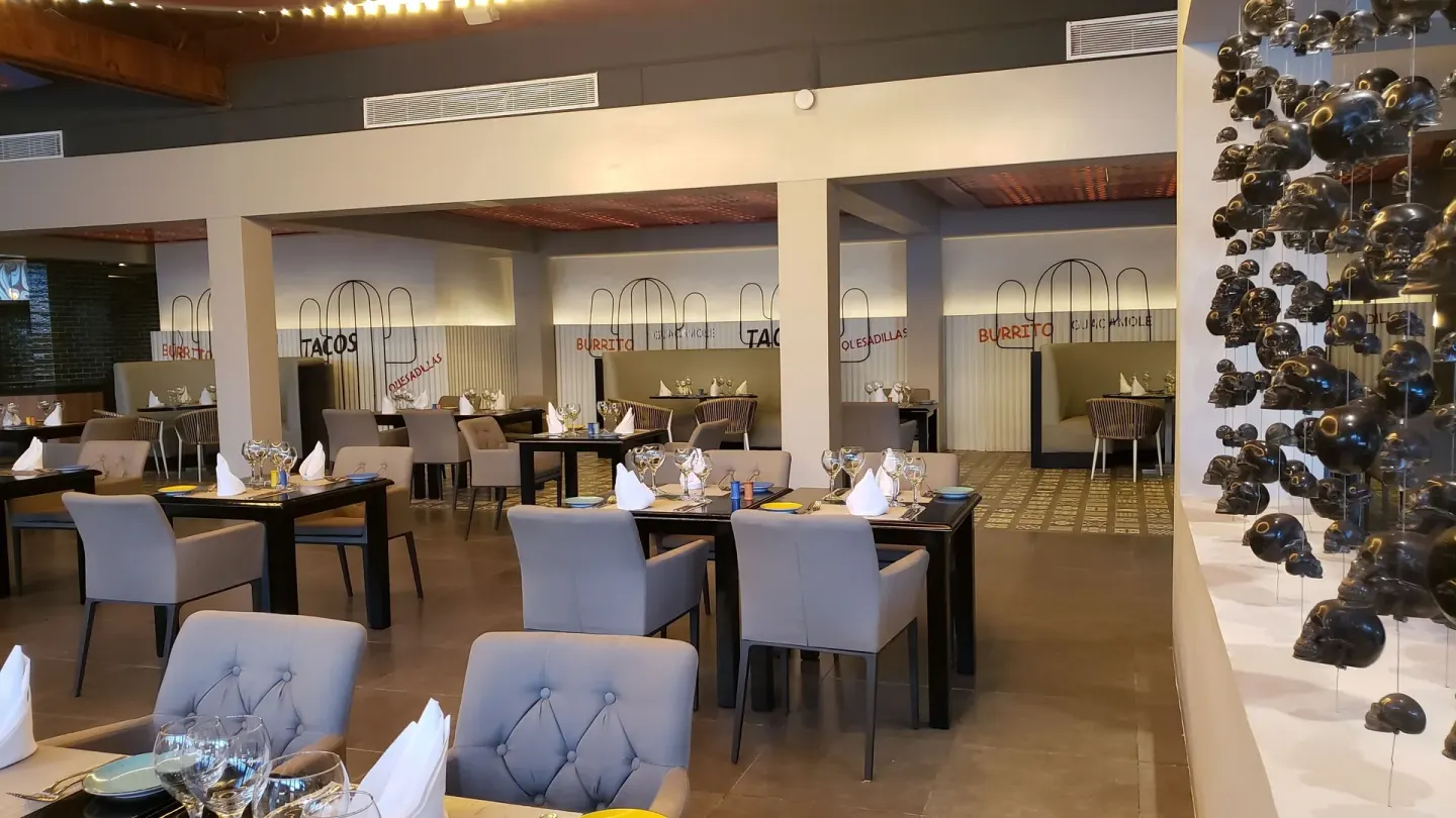 Mexican restaurant dining room with set tables at Princess Family Club Bavaro.