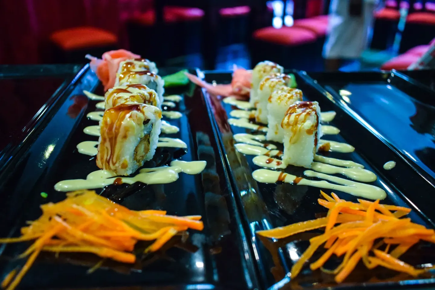Sushi rolls plated with sauces and shredded carrots at Princess Family Club Bavaro.