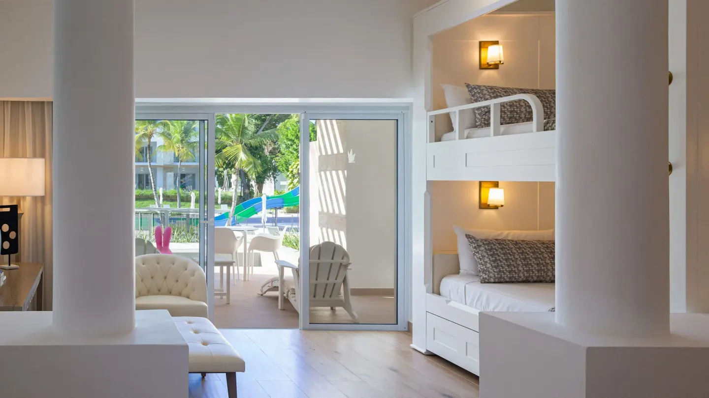 Family Club Junior Suite Swimout bunk beds and patio doors at Princess Family Club Bavaro.