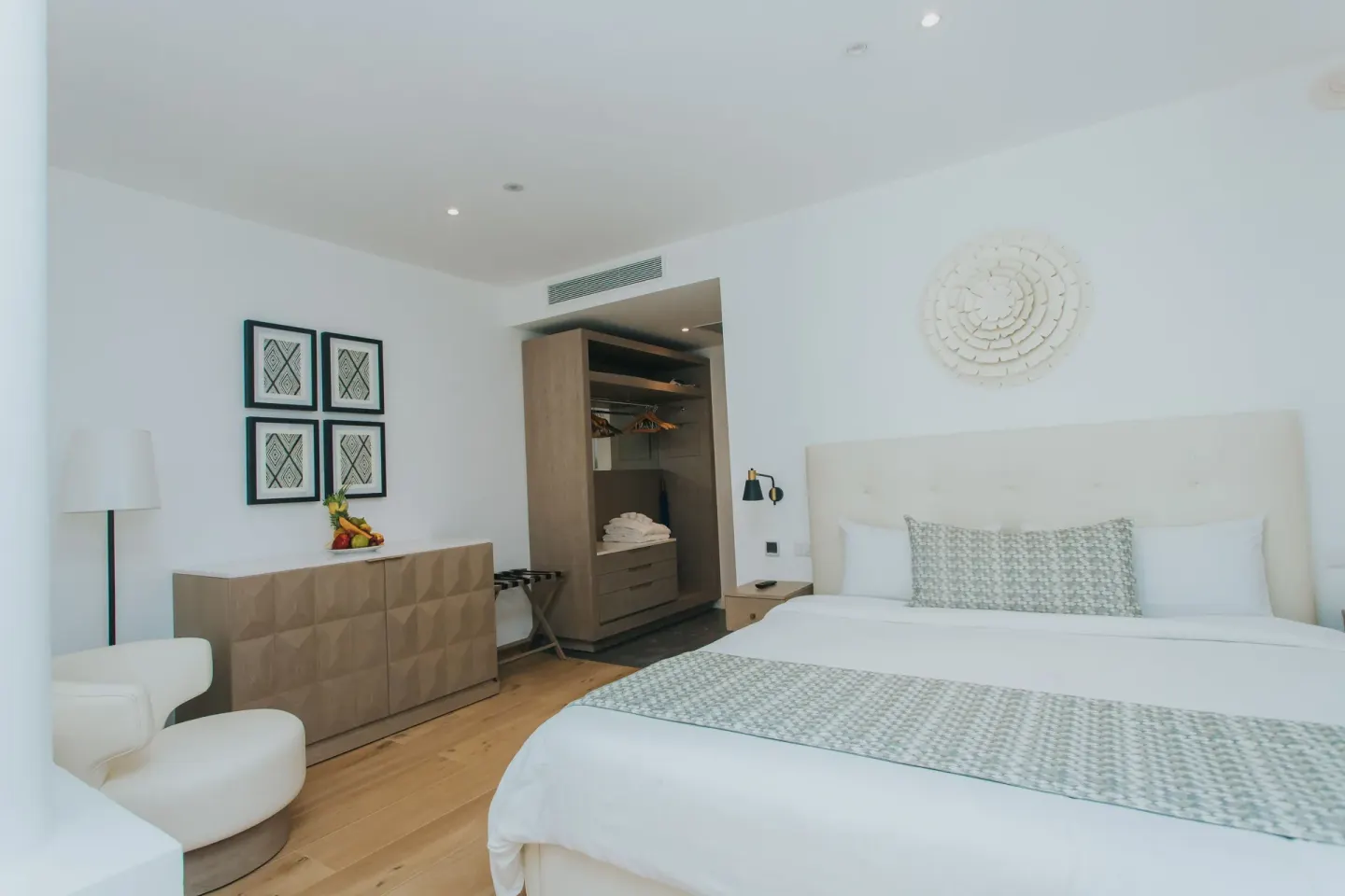 Family Club Junior Suite Swimout king bed and open closet at Princess Family Club Bavaro.