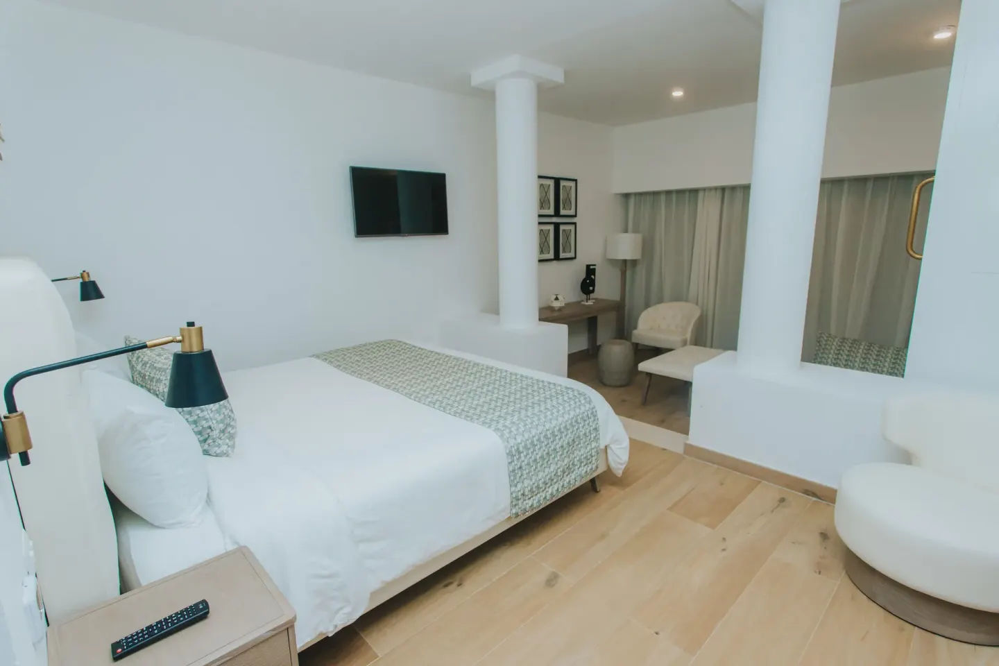 Family Club Junior Suite Swimout king bed and sunken seating nook at Princess Family Club Bavaro.