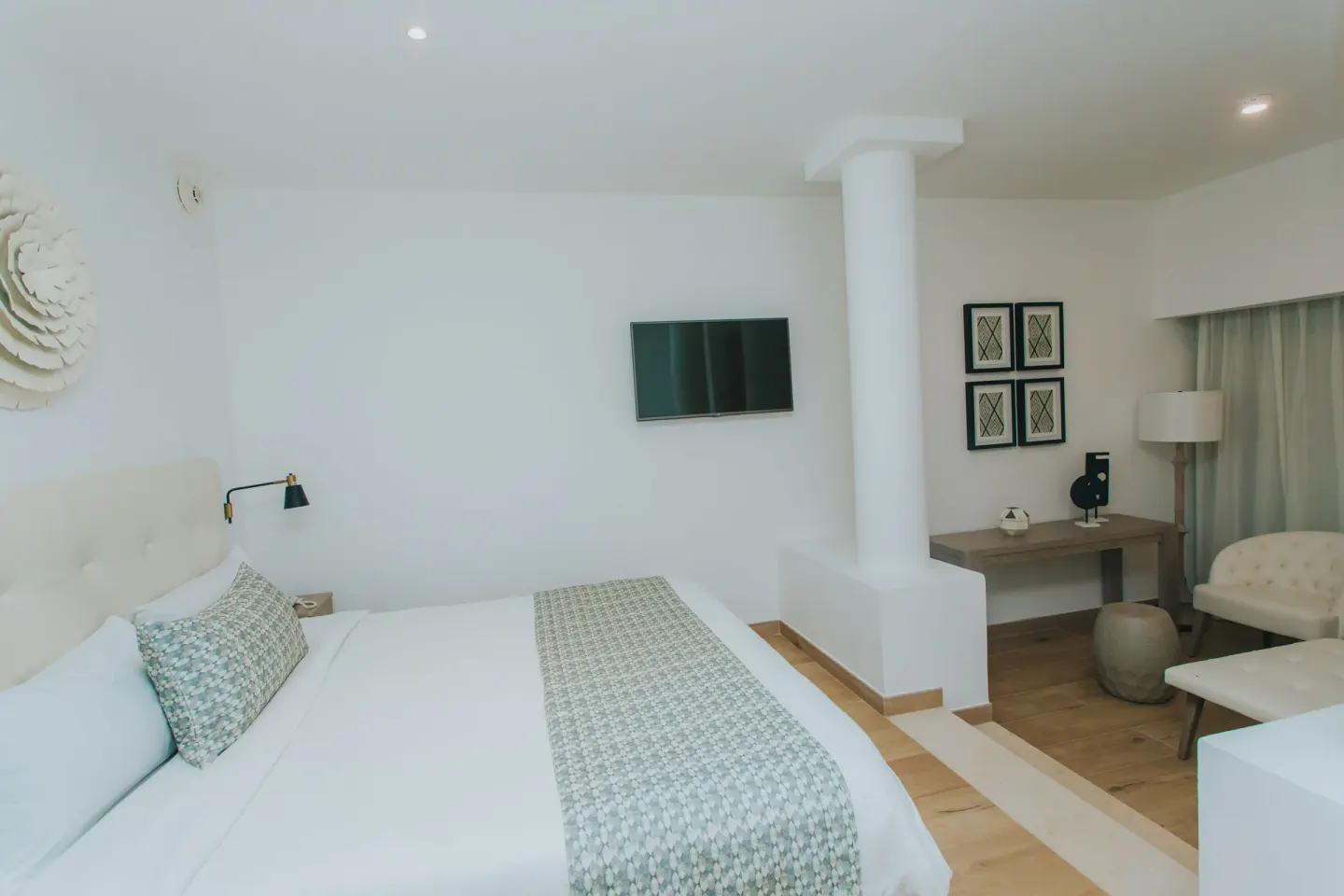 Family Club Junior Suite Swimout king bed facing TV and desk at Princess Family Club Bavaro.
