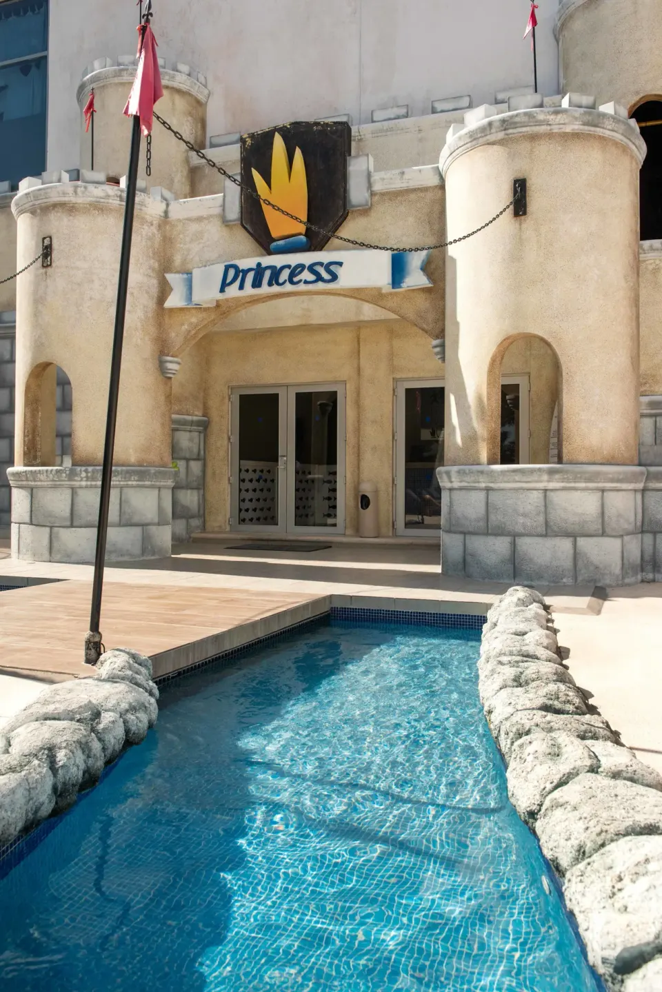 Castle-themed entrance with a shallow water feature at Princess Family Club Riviera.