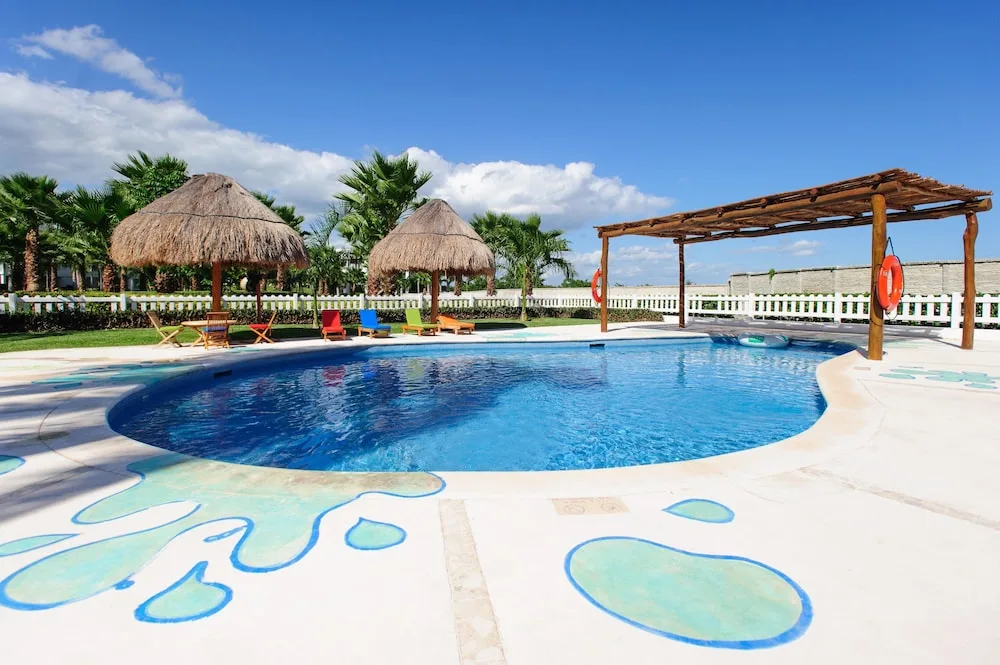Children's pool with palapas and colorful loungers at Princess Family Club Riviera.