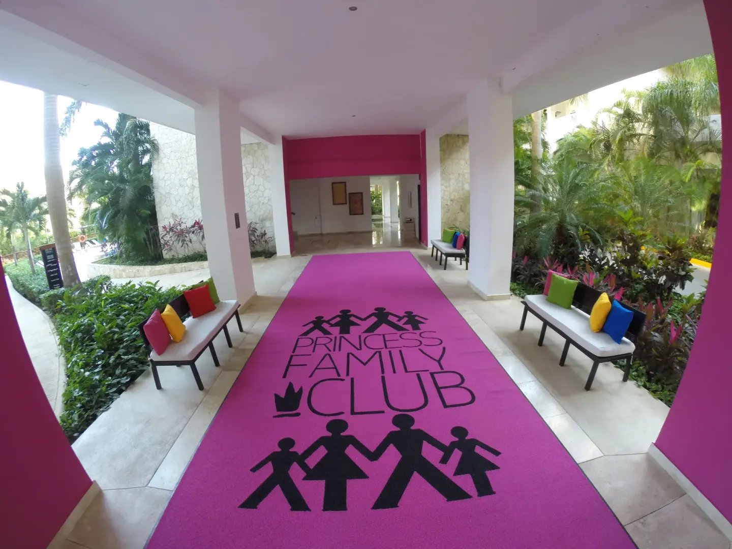 A covered walkway with a pink family club carpet at Princess Family Club Riviera.