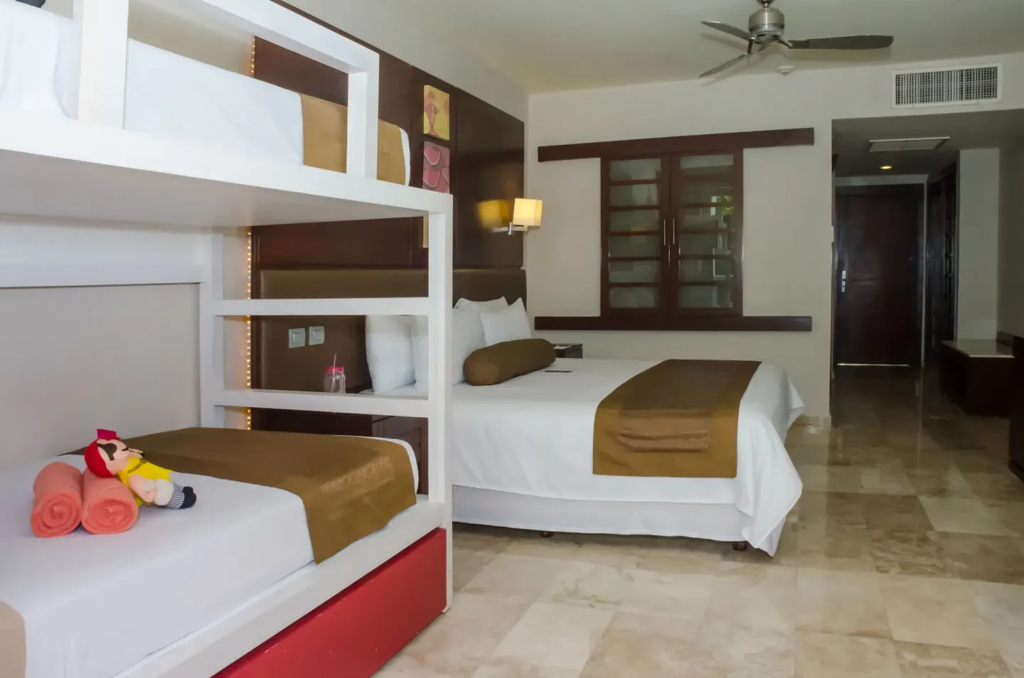 Family guest room with bunk beds and a queen bed at Princess Family Club Riviera.