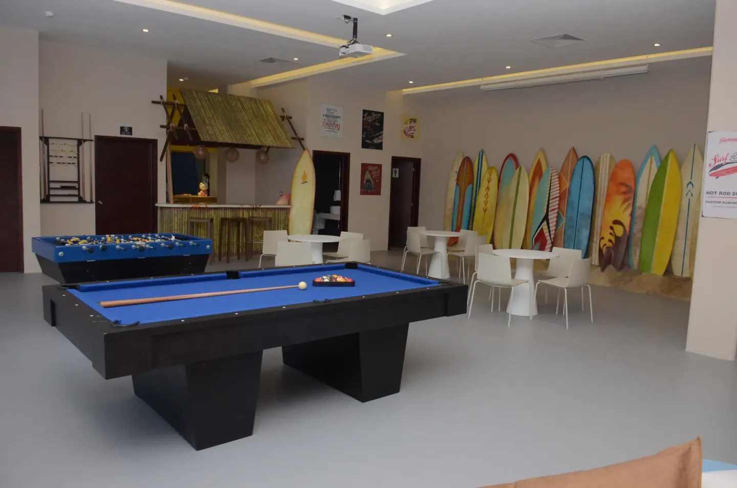 Game room with pool and foosball tables and surfboard décor at Princess Family Club Riviera.
