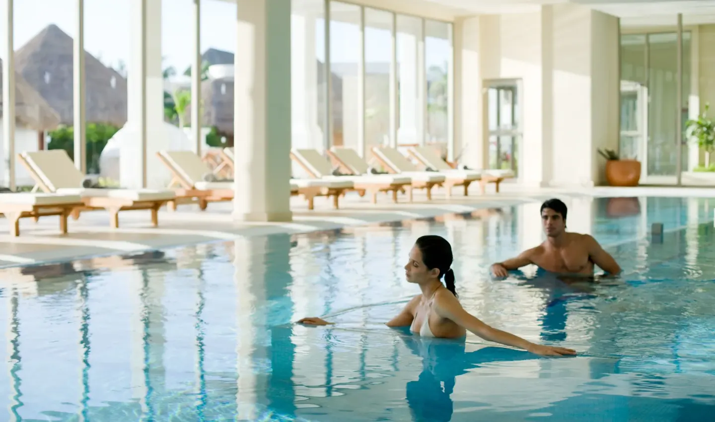 Guests relax in a bright indoor pool at Princess Family Club Riviera.