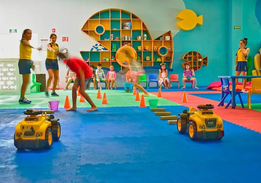 Children play games in a colorful kids club room at Princess Family Club Riviera.