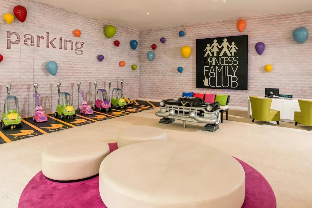 Kids' toy car parking play area with colorful wall balloons at Princess Family Club Riviera.