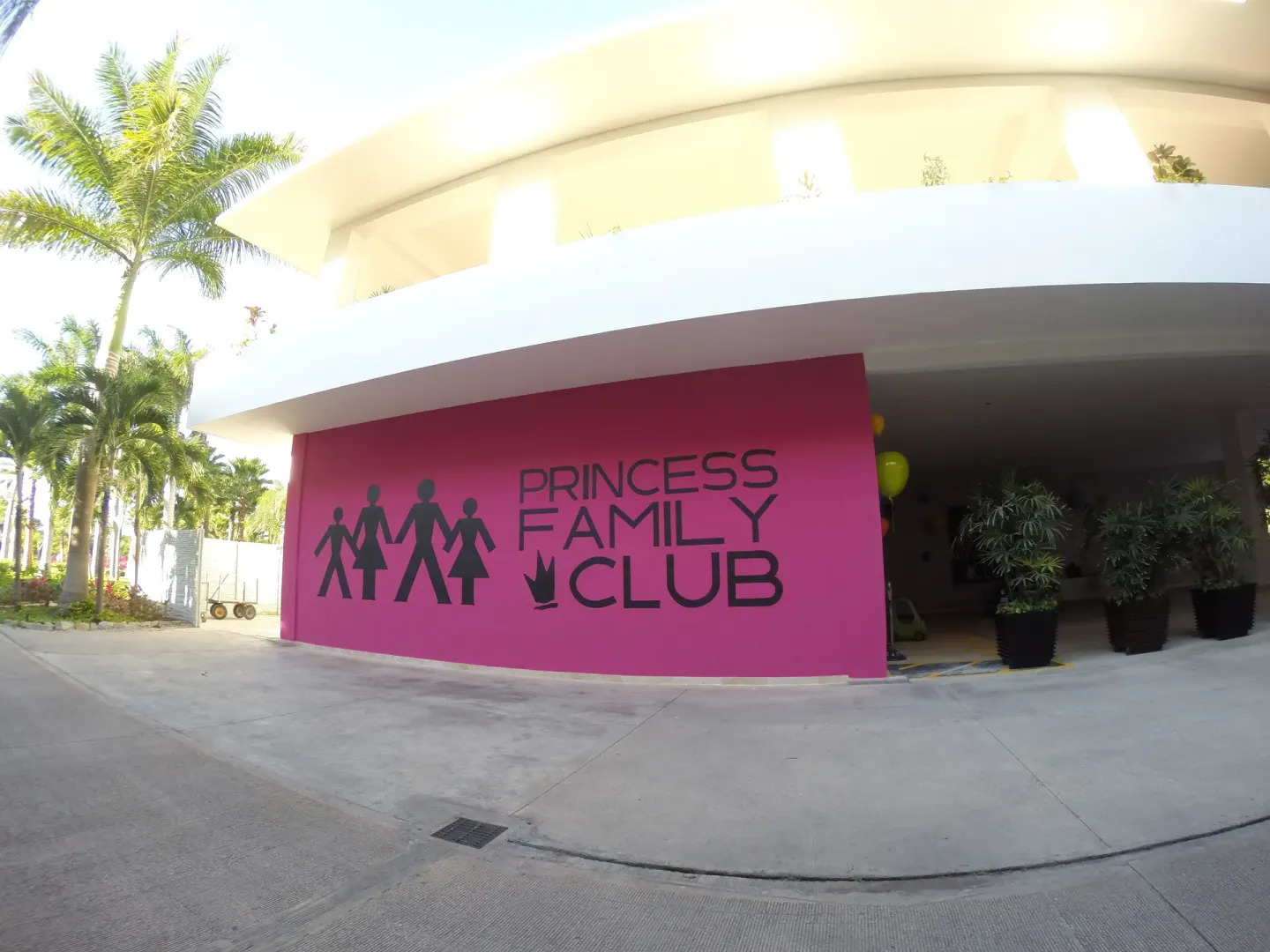 A pink Princess Family Club Riviera exterior wall and entrance at Princess Family Club Riviera.