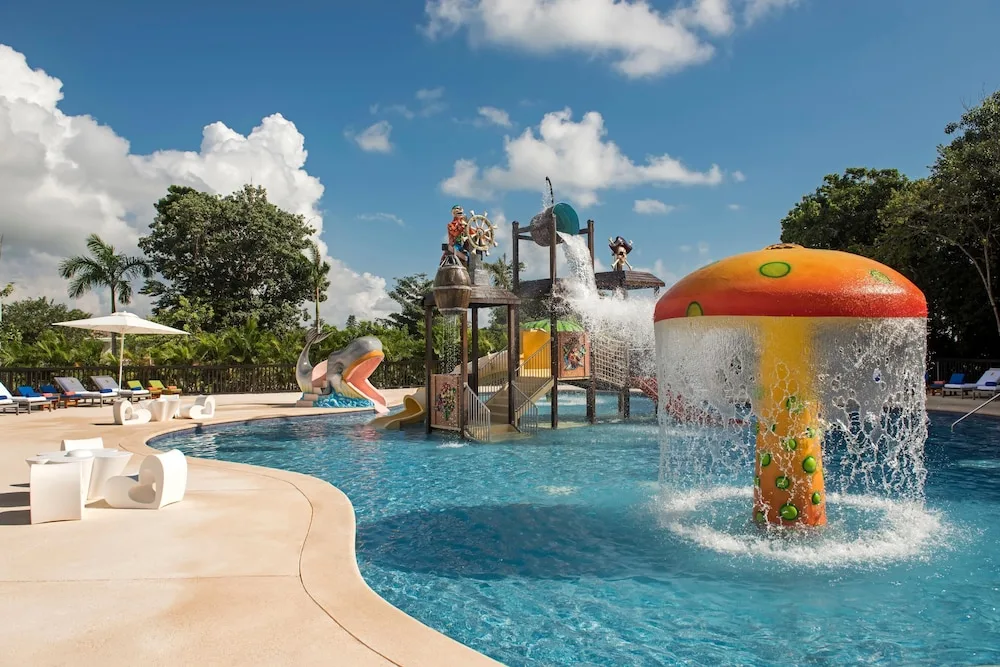 Splash pool with mushroom fountain and pirate play structure at Princess Family Club Riviera.