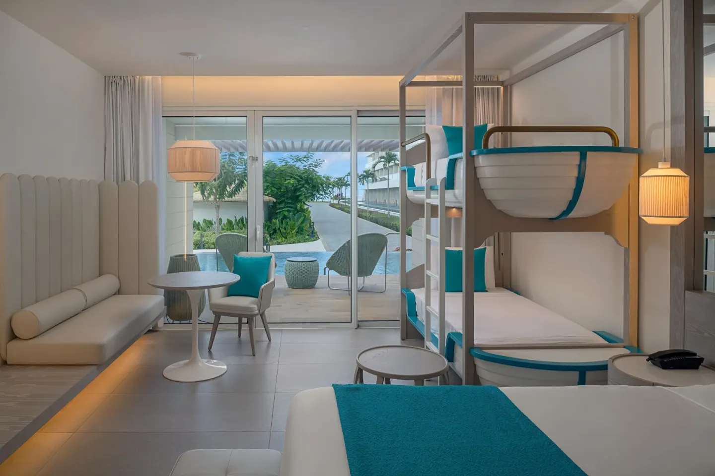 Family guest room with bunk beds and terrace access at Princess Grand Jamaica Resort.
