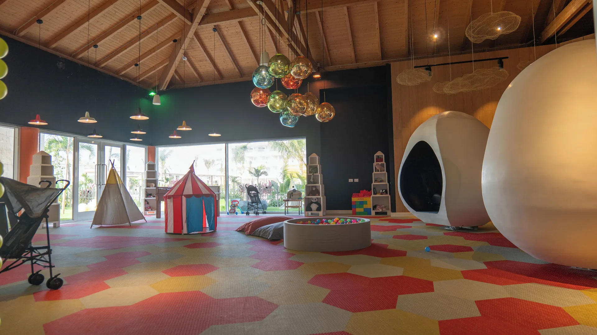 Indoor kids' playroom with tents, ball pit, and pod seating at Princess Grand Jamaica Resort.