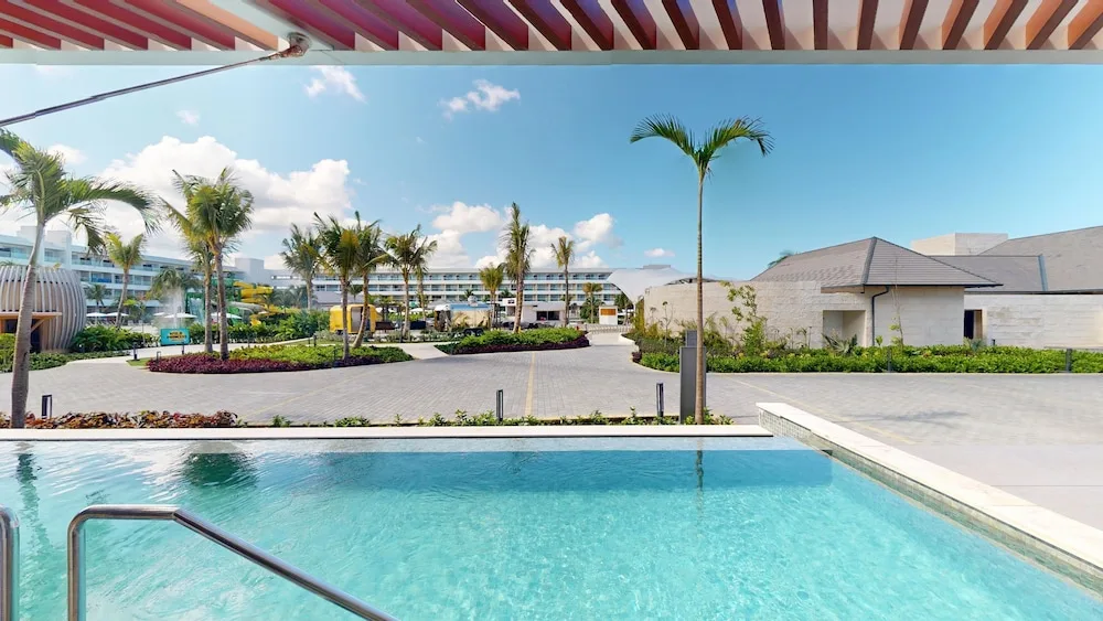 Pool edge and landscaped resort buildings at Princess Grand Jamaica Resort.