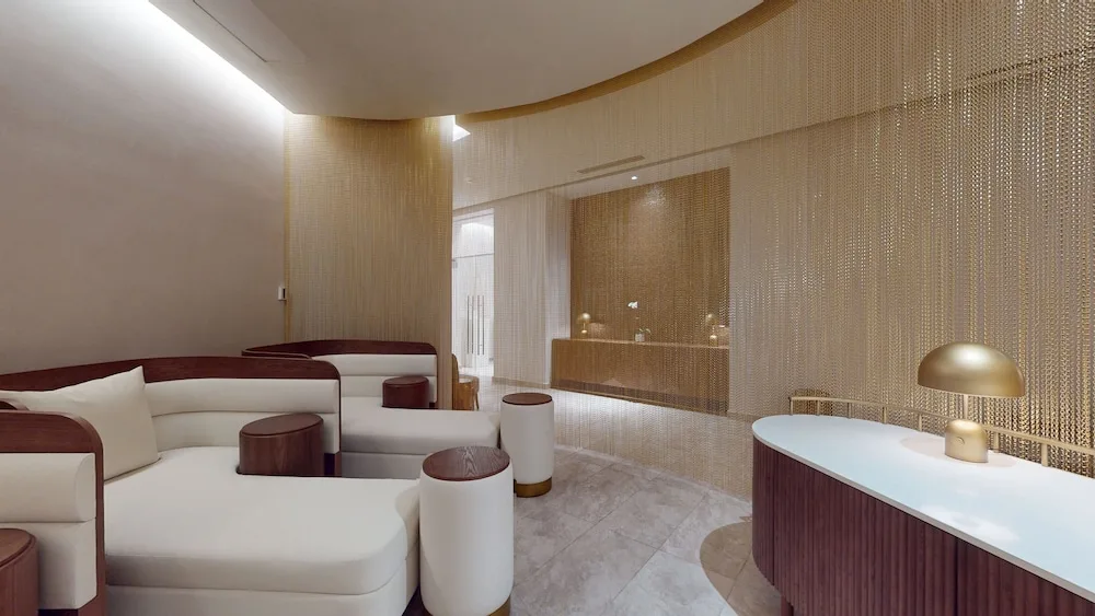 Spa lounge with curved chaise seating and a reception desk at Princess Grand Jamaica Resort.