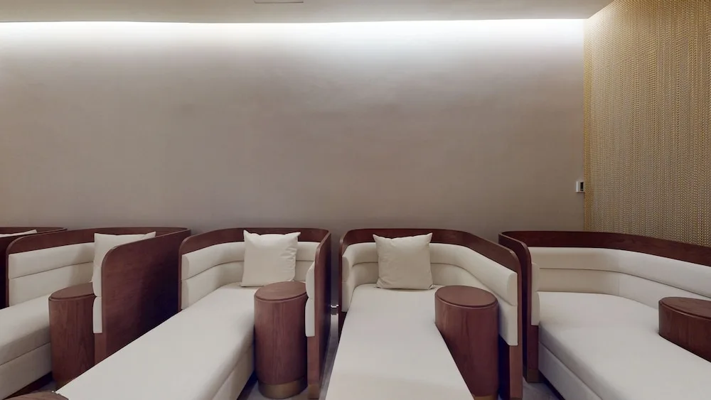 Spa relaxation loungers with pillows and side tables at Princess Grand Jamaica Resort.
