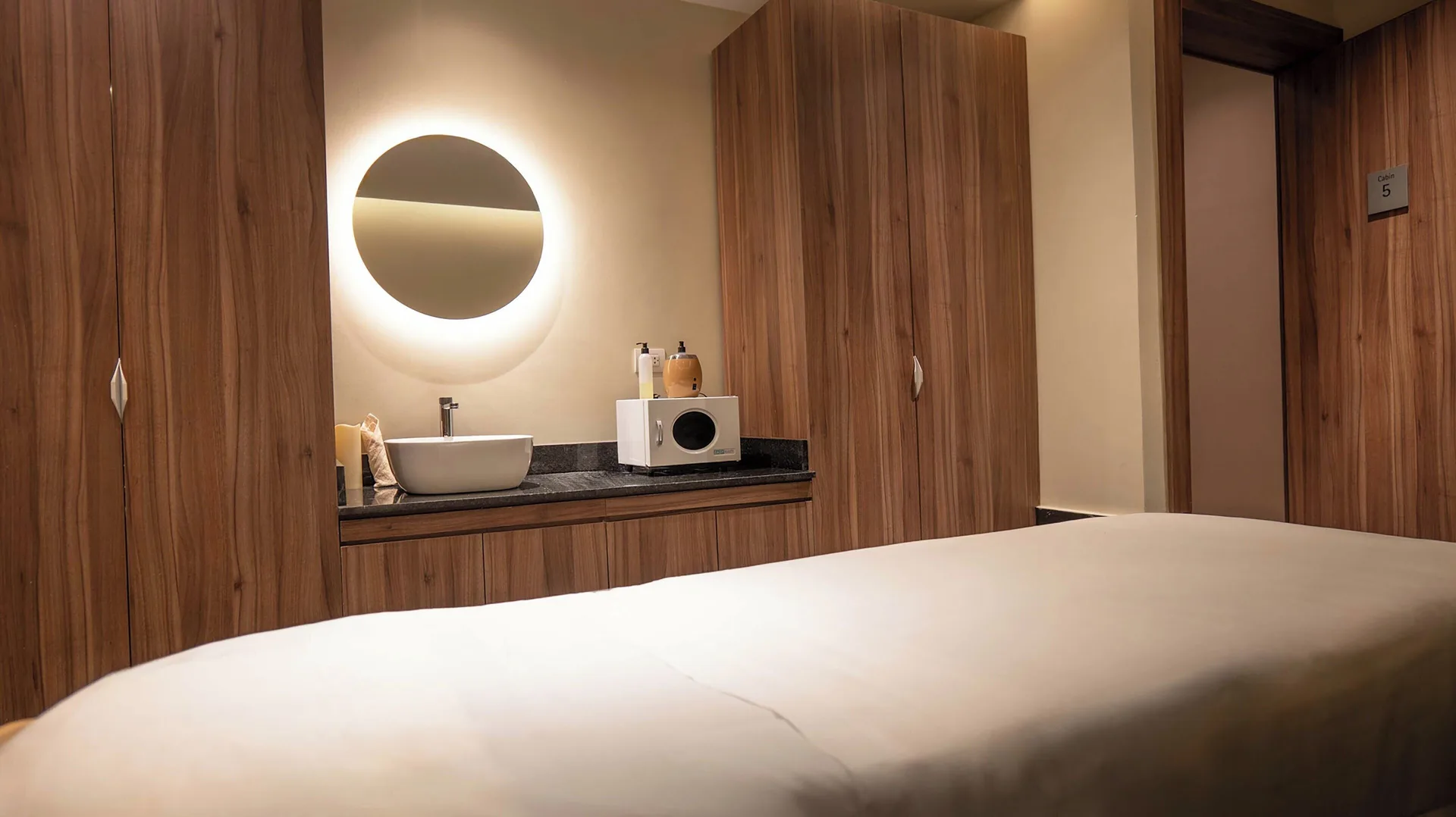 Spa treatment room with massage bed and vanity at Princess Grand Jamaica Resort.