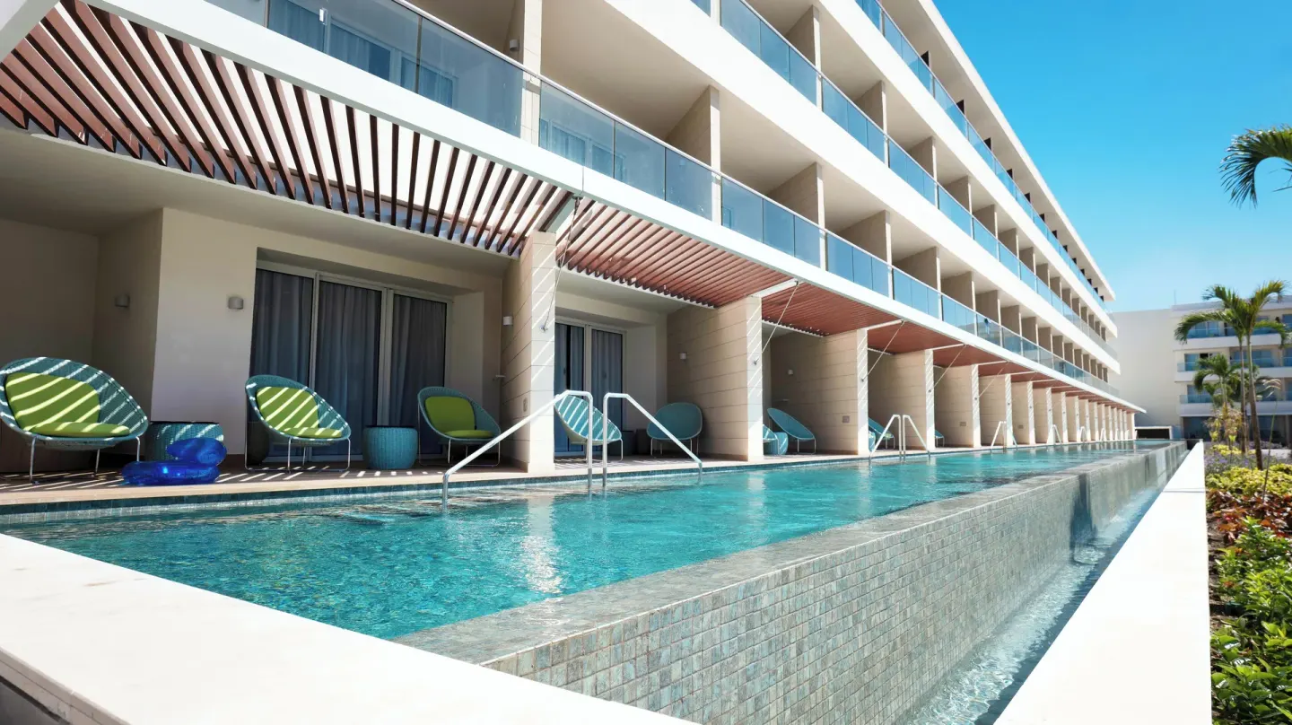 Swim-up pool along guest room terraces at Princess Grand Jamaica Resort.