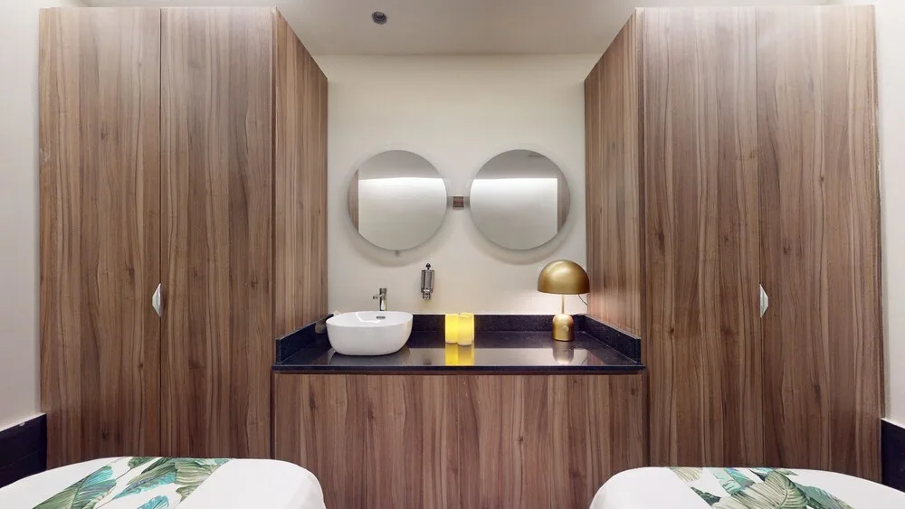Spa treatment room with twin massage beds and vanity at Princess Grand Jamaica Resort.