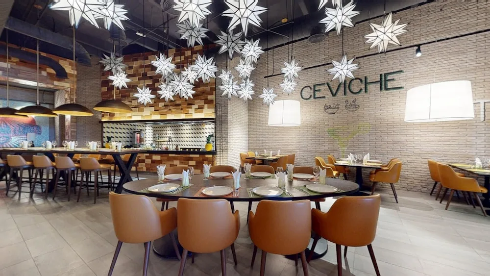 Ceviche restaurant dining room with star lights and round tables at Princess Grand Jamaica Resort.